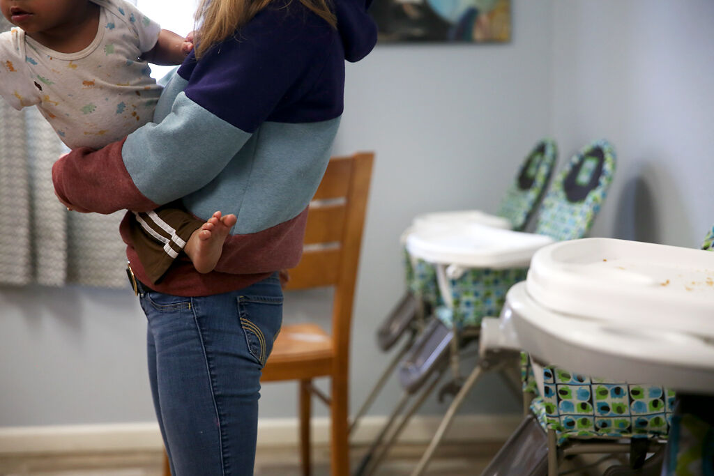 Youth specialist Tawnie Nelson holds a child